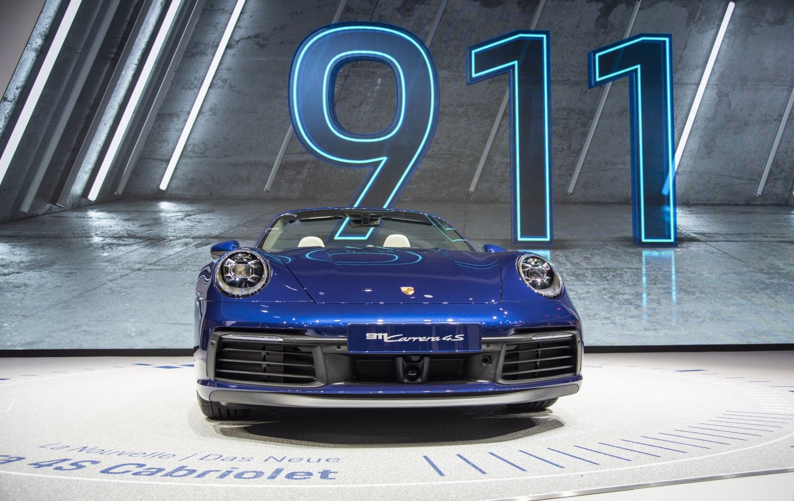 Front view of a convertible sports vehicle with LED headlights and wide grille