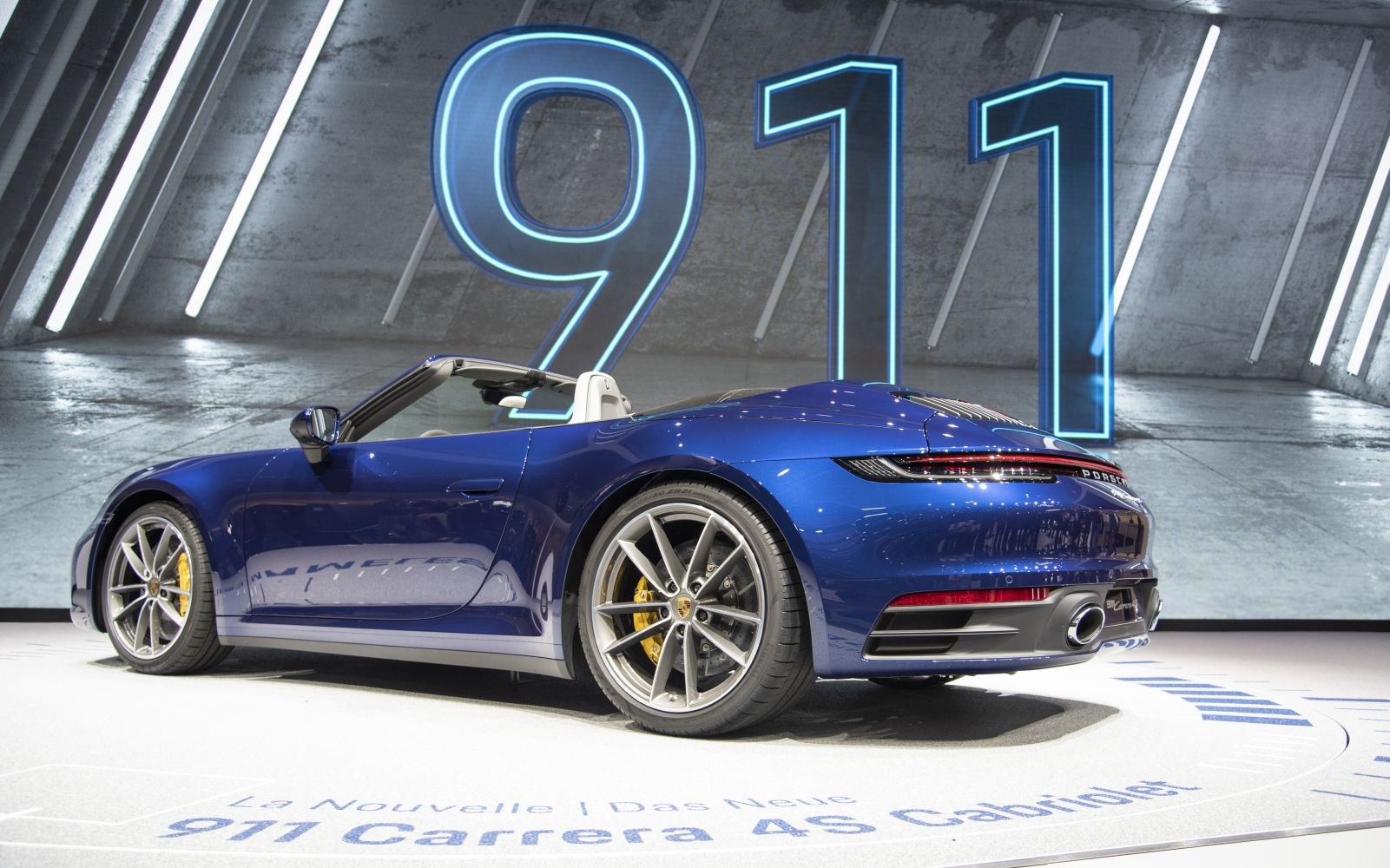 Sleek rear view with stylish alloy wheels of blue convertible sports car