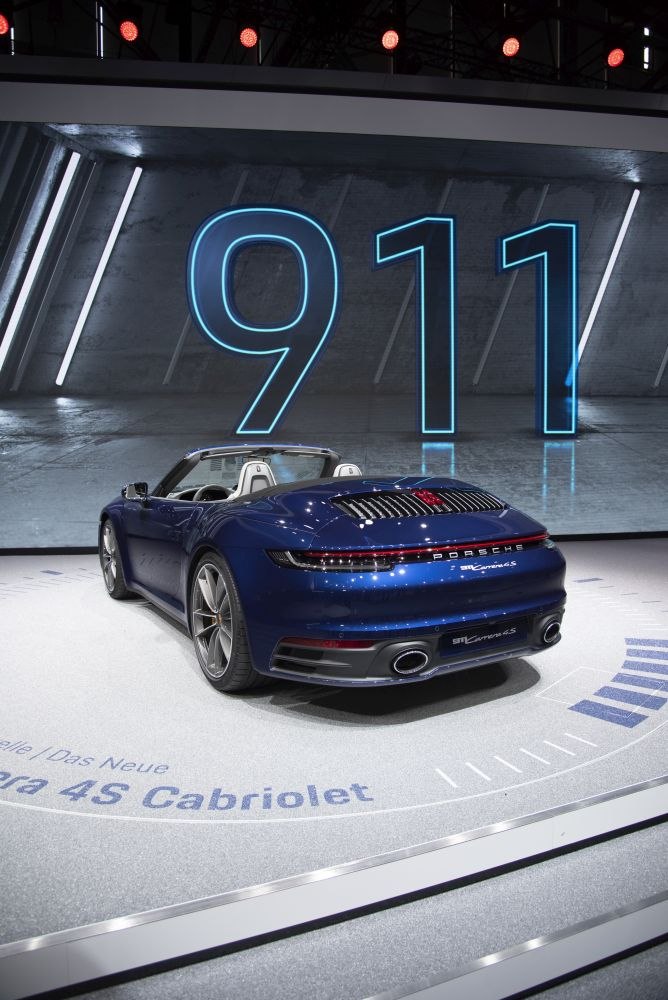 Rear view of blue convertible with twin exhaust and sleek design