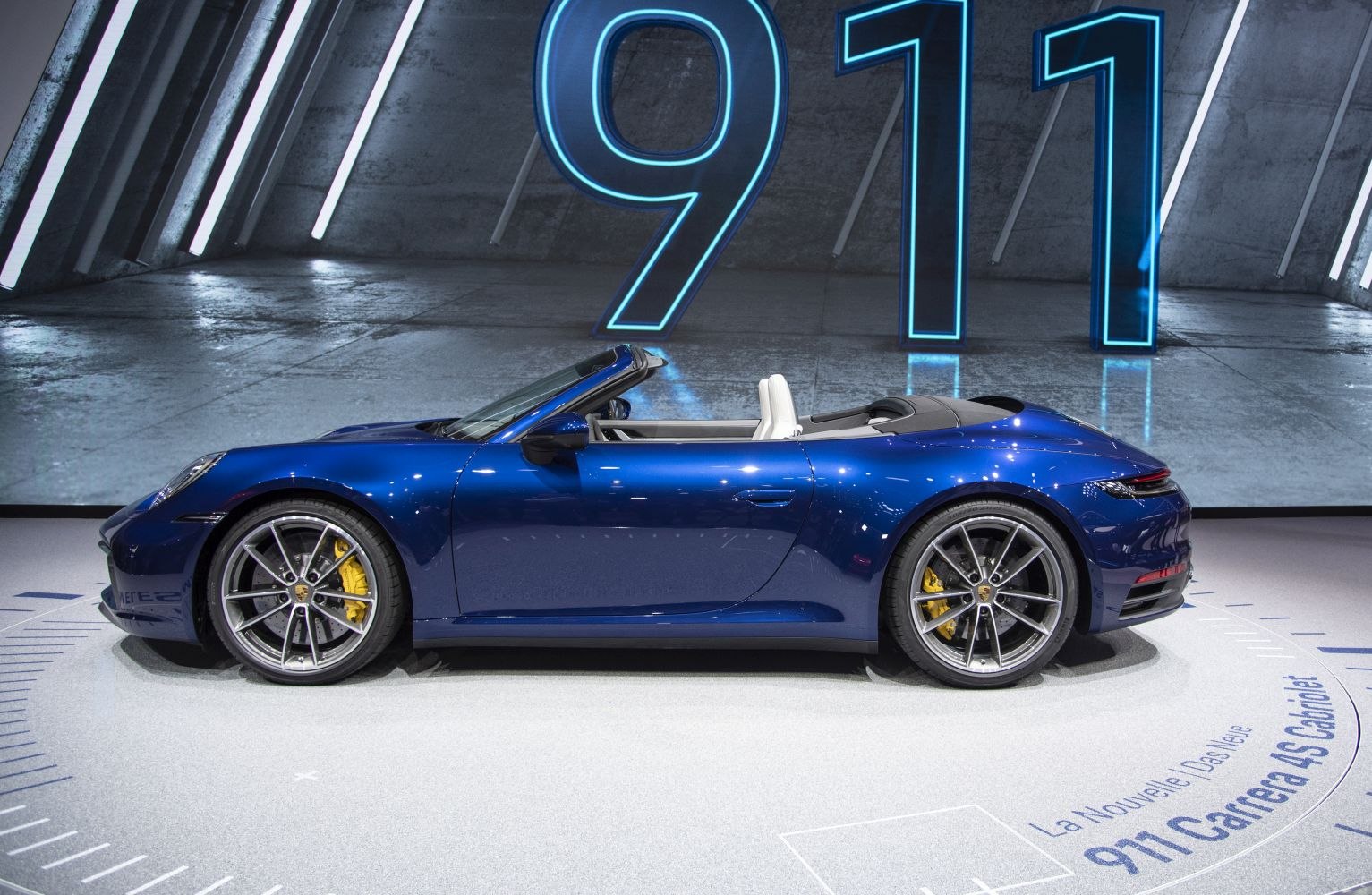 Side profile of blue convertible with alloy wheels and yellow brake calipers