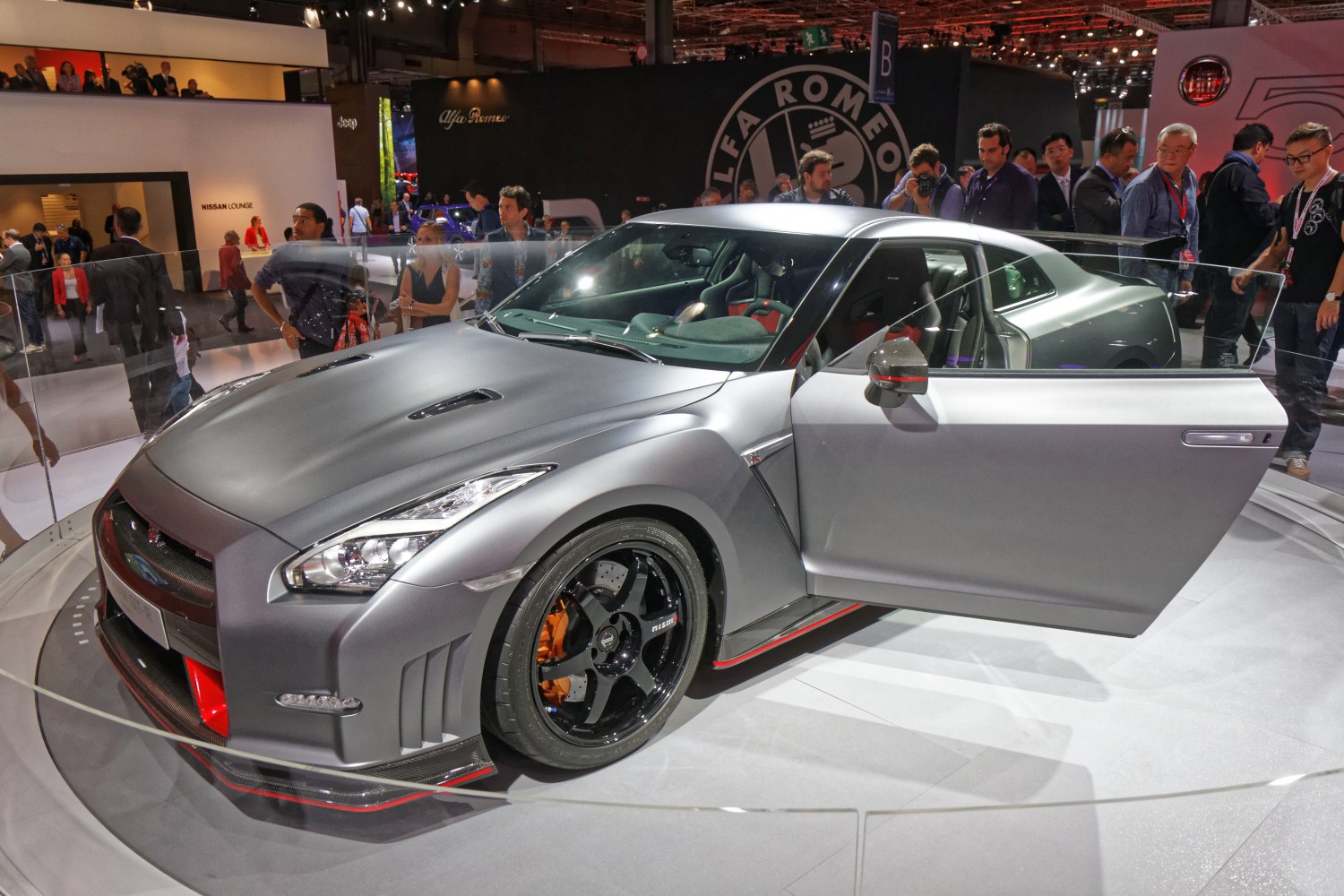 Matte gray sports coupe with aerodynamic front and open driver's door