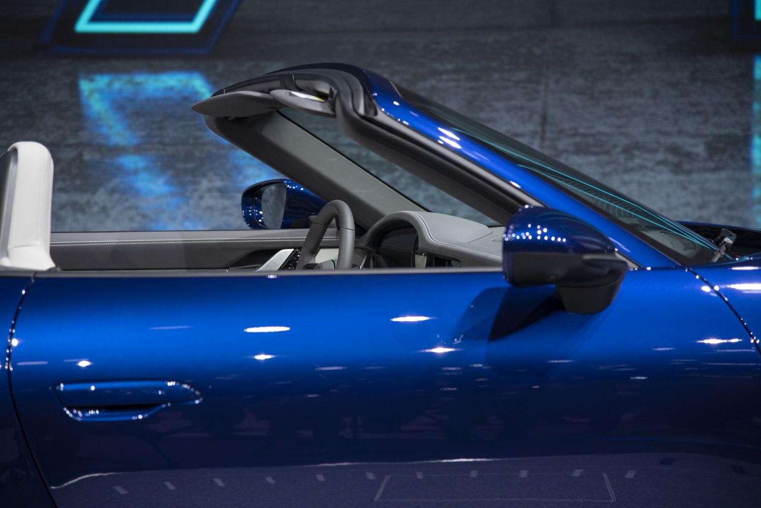 Convertible roof mechanism and side profile in vibrant blue