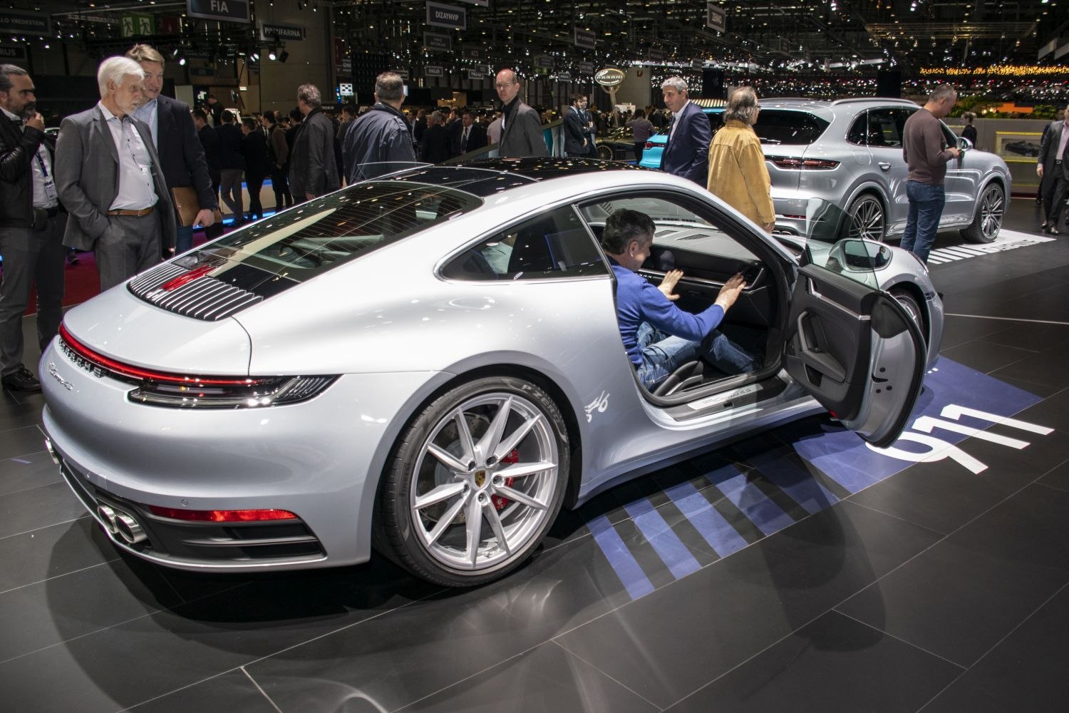 Rear profile with open driver door showing interior and alloy wheels.