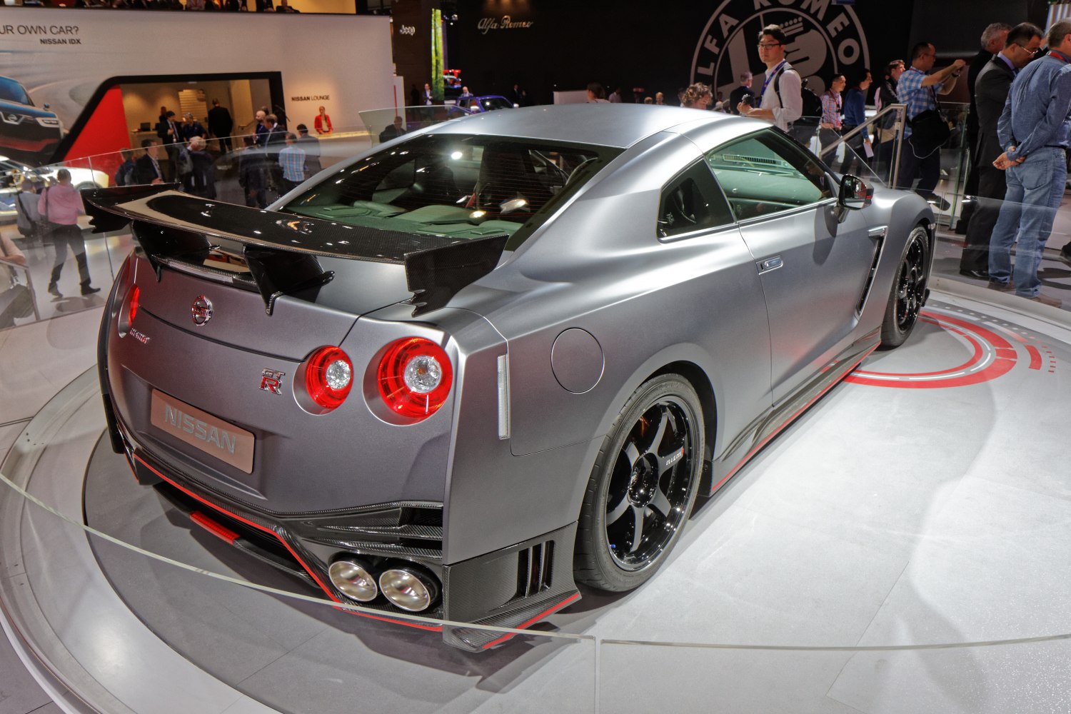 Rear view of a sports coupe with carbon fiber wing and quad exhausts