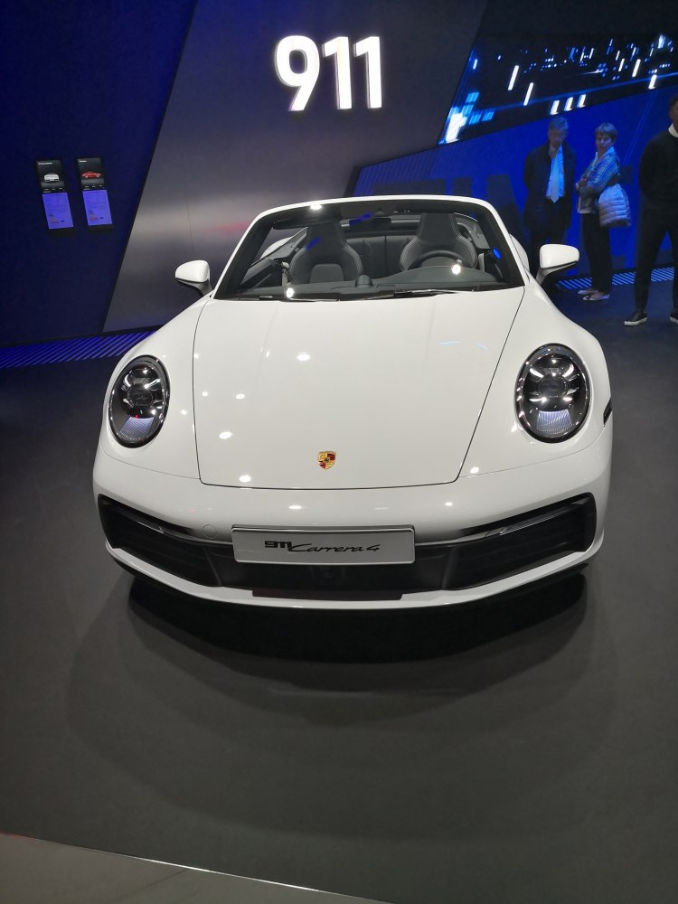 Front view of white convertible with round headlights and sporty design