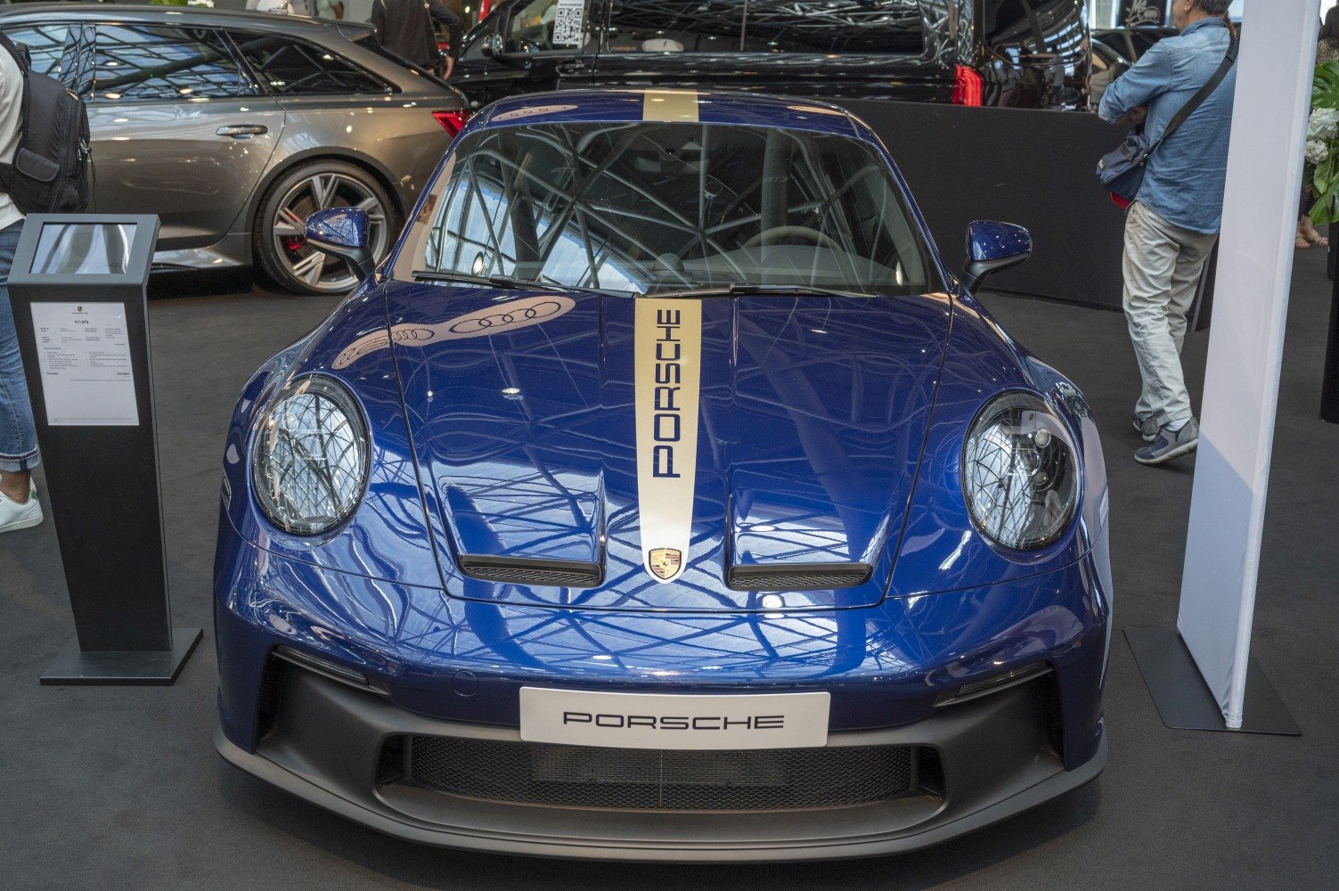 Front view of a blue Porsche 911 with racing stripe and hood vents