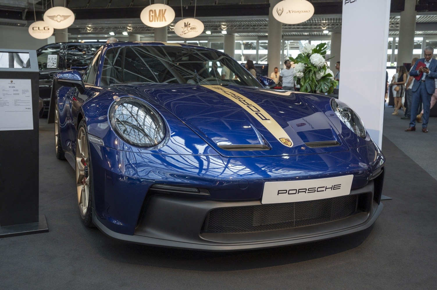 Blue sports coupe with aerodynamic front and rounded headlights
