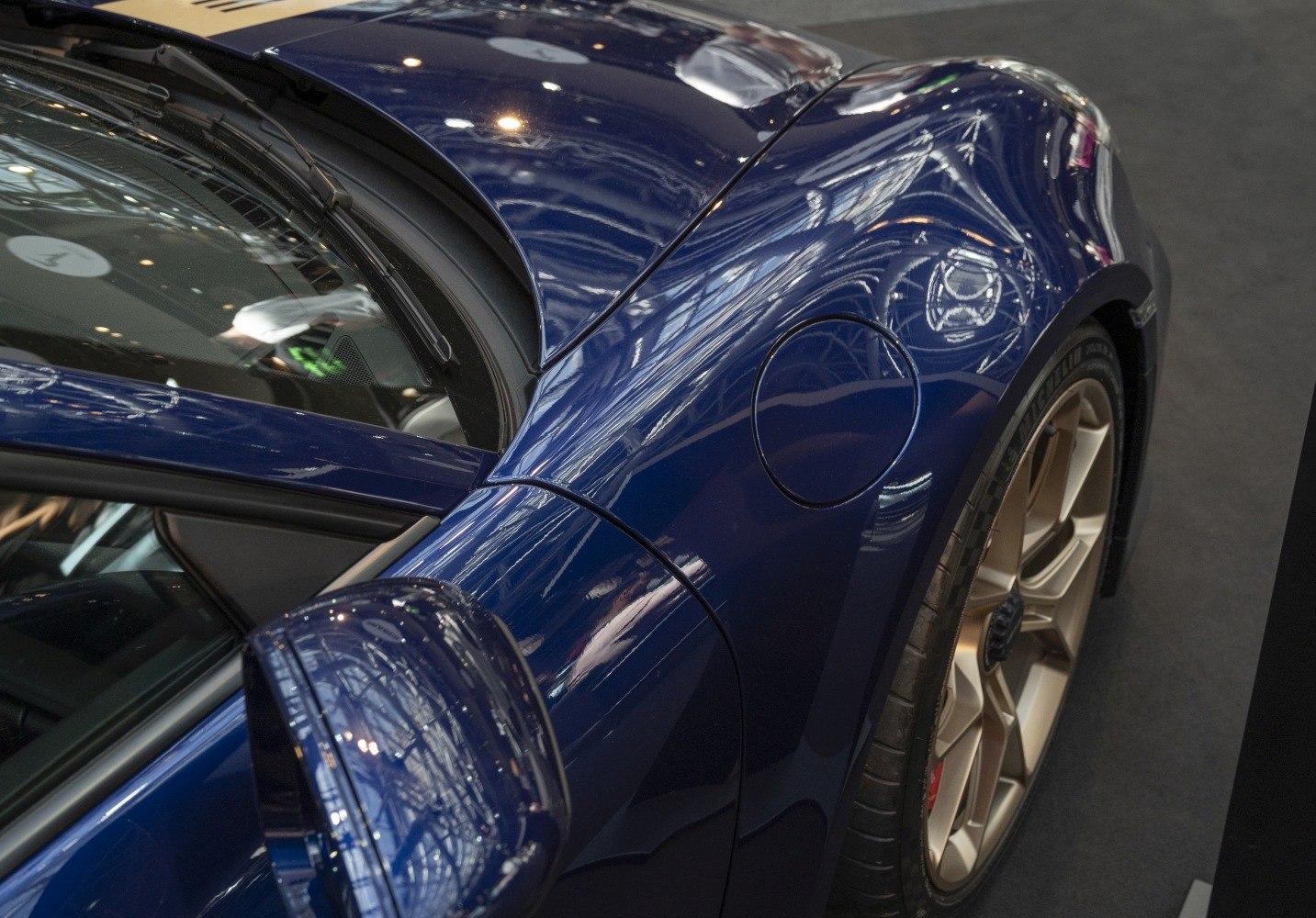 Rear fender, side mirror, and alloy wheel close-up