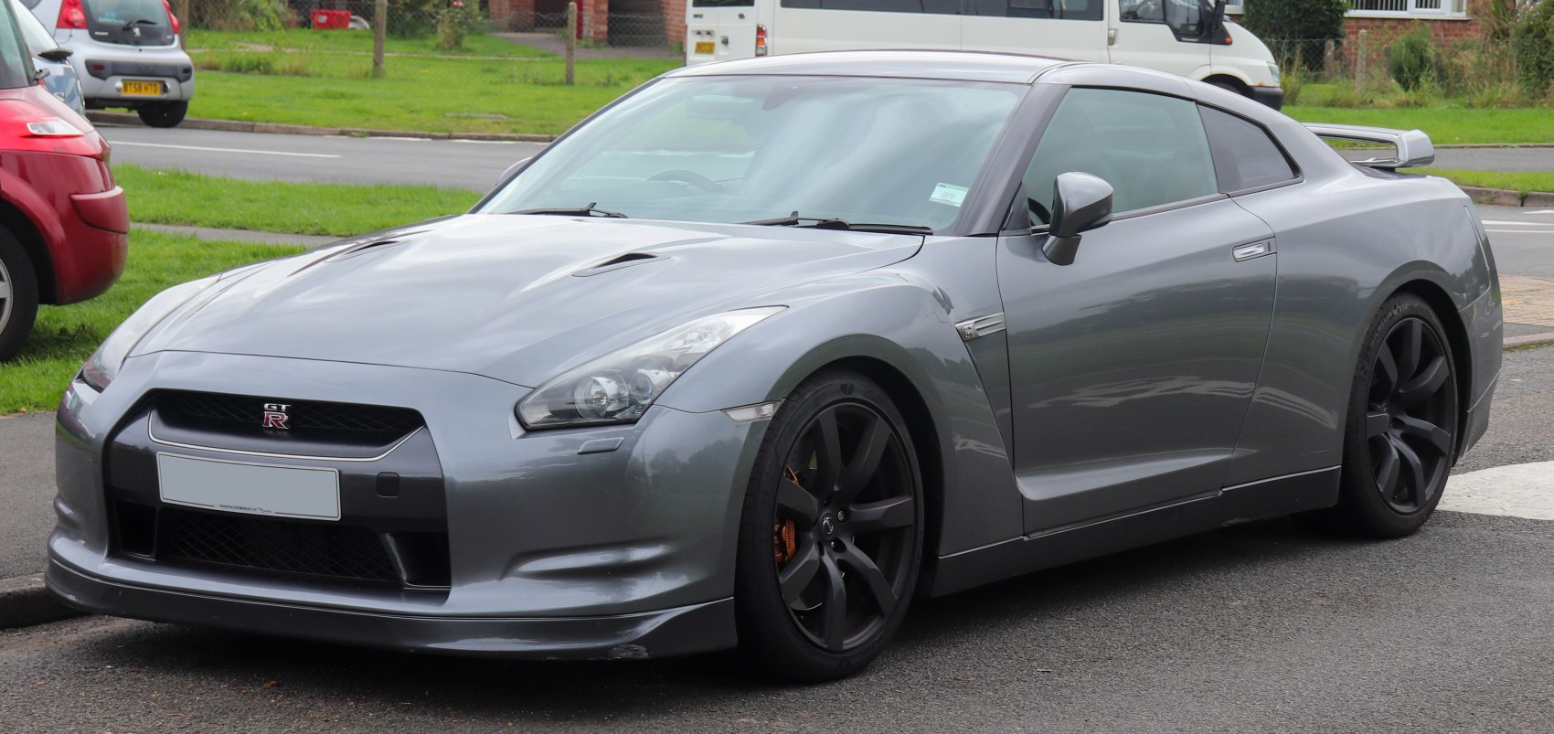 Gray sports coupe front three-quarter view with aerodynamic design and dark wheels