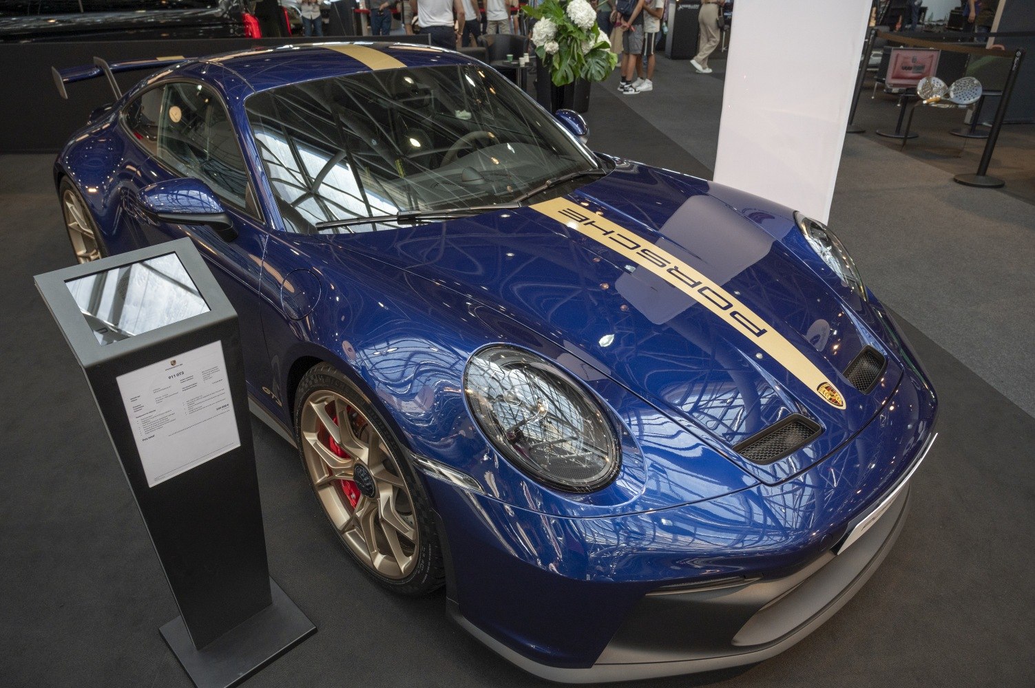 Blue Porsche with gold racing stripe and front hood vents