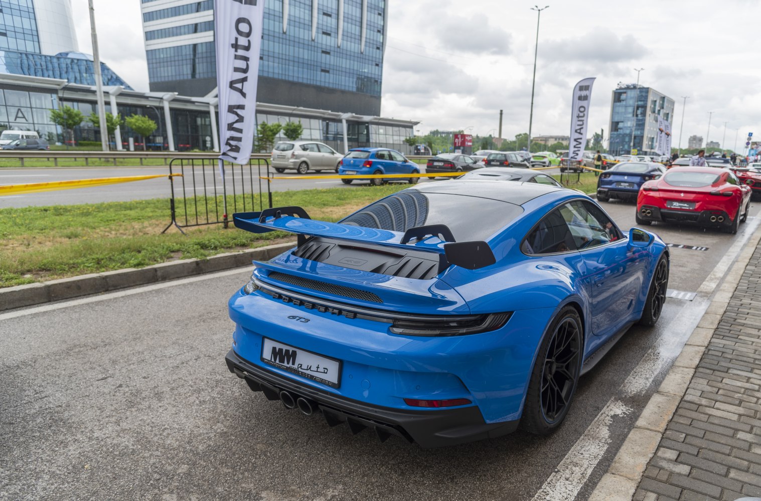 Blue sports coupe rear with large rear wing and diffuser