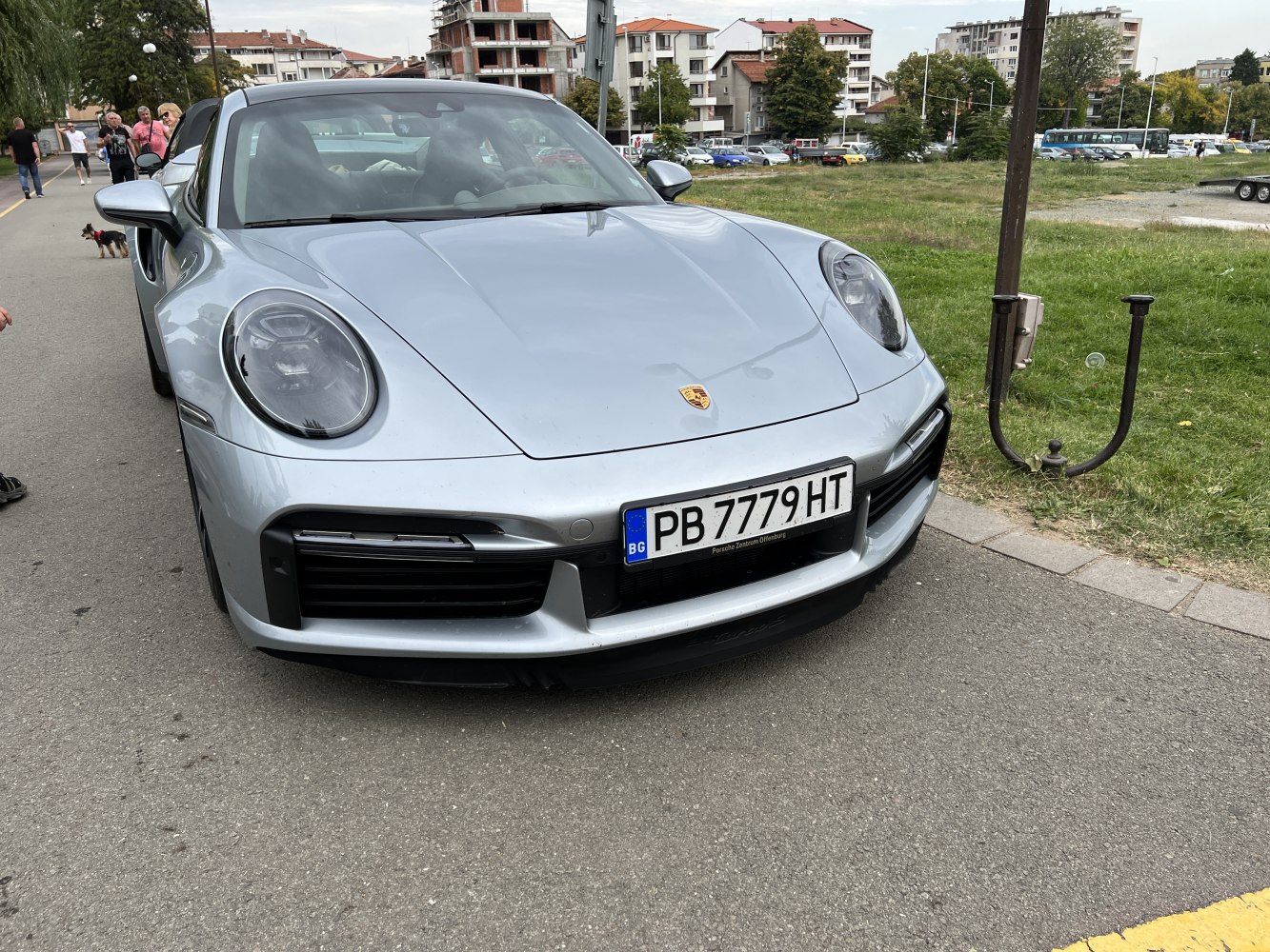 Silver sports coupe front with round headlights and wide grille