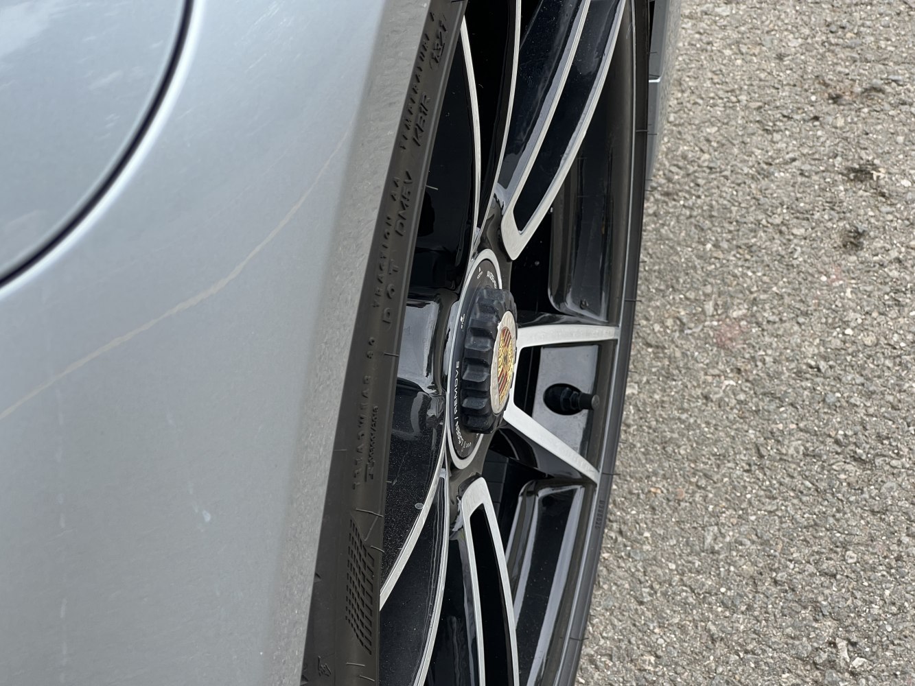 Close-up of alloy wheel and tire with emblem center cap