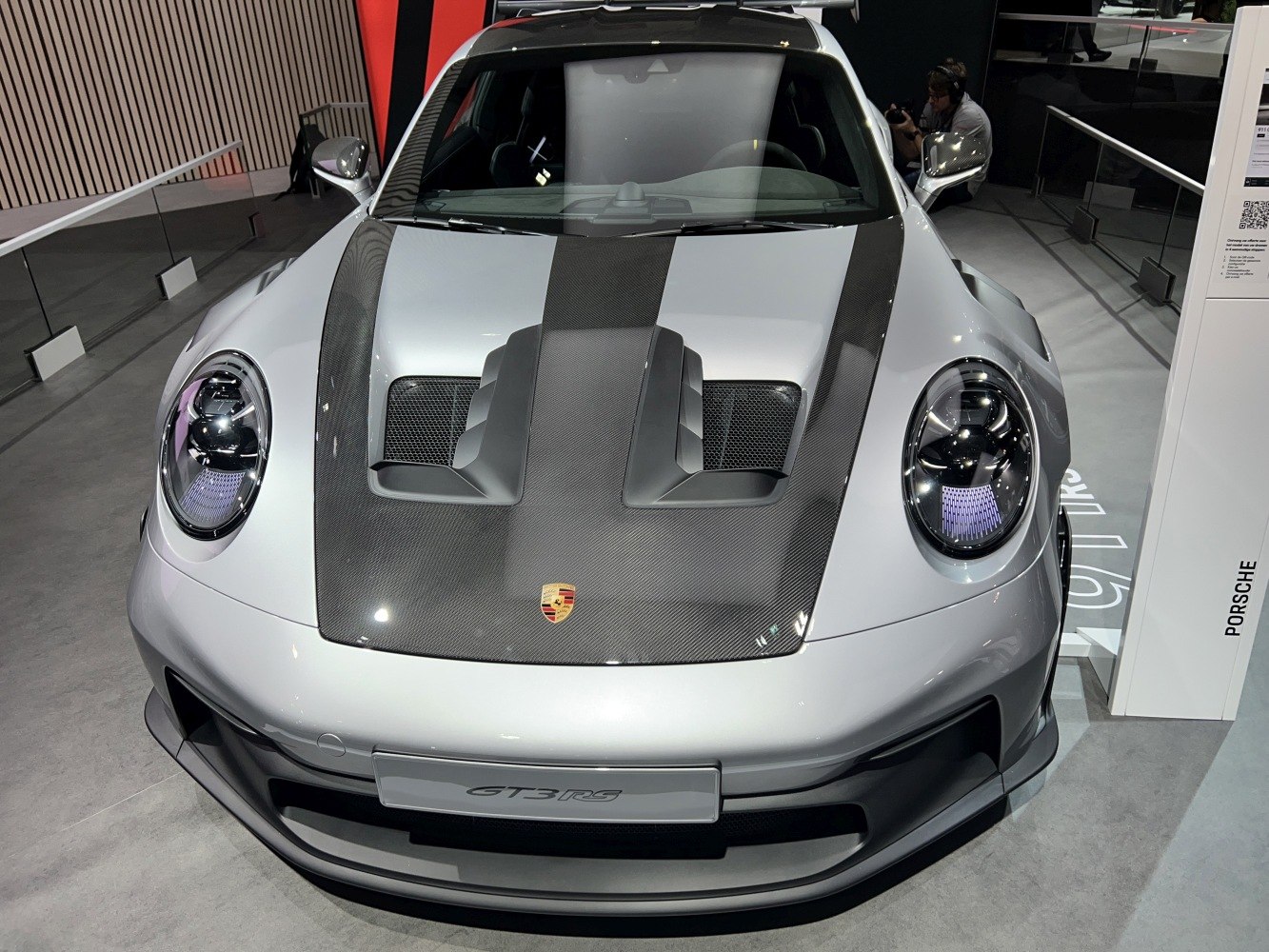Front view of a sports car with carbon fiber hood and aerodynamic vents
