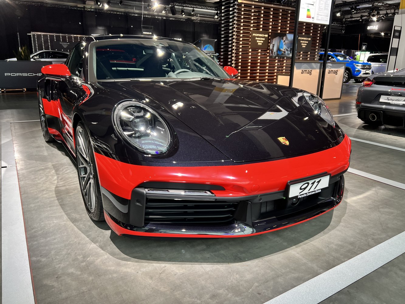 Close-up front view with round headlights and red trim accents