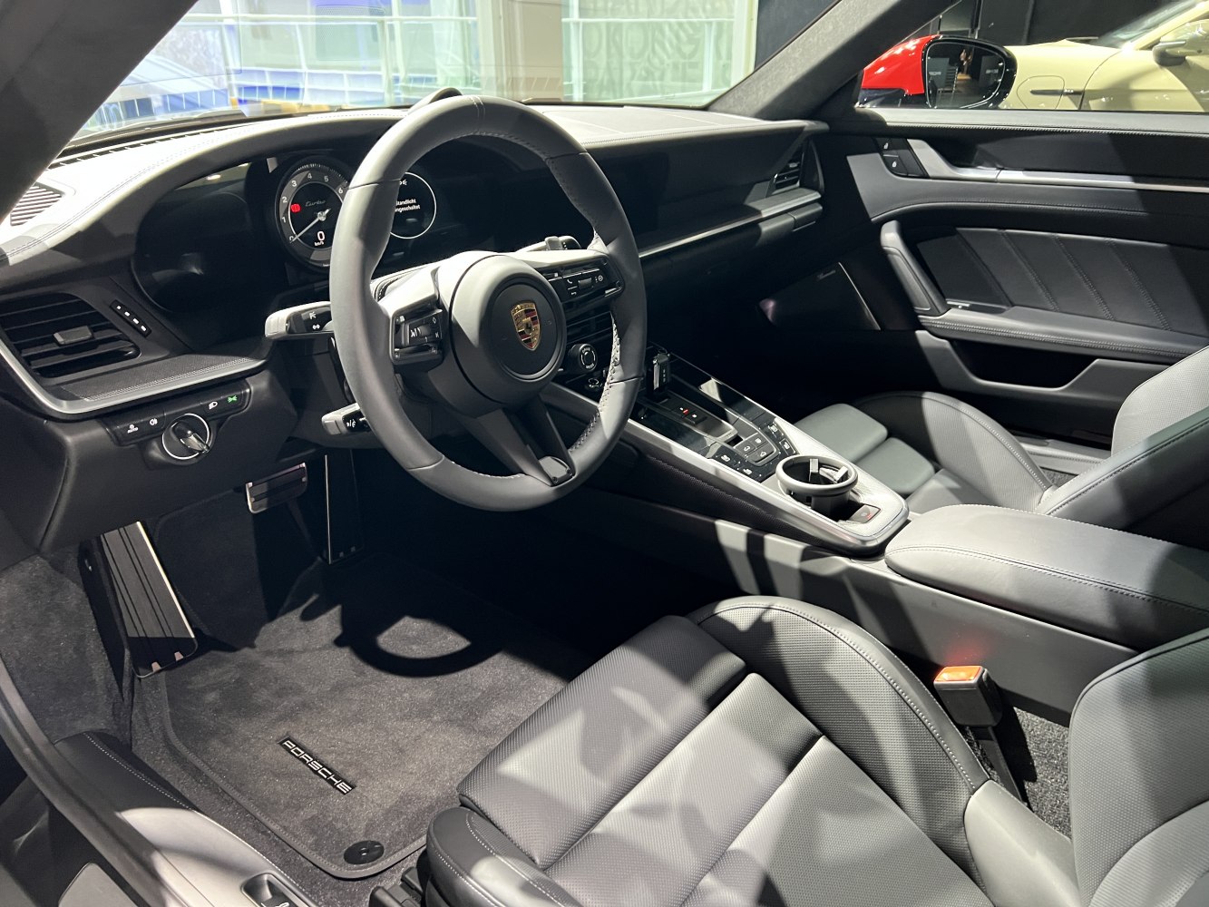 Luxury sports car interior with leather seats and advanced cockpit.