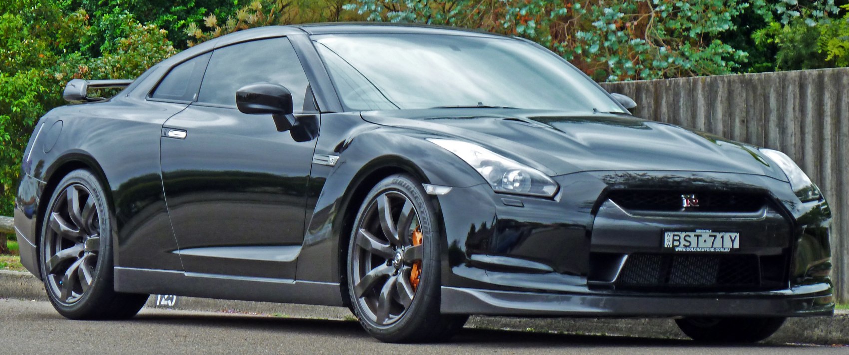 Black sleek performance coupe with aggressive aerodynamics and alloy wheels