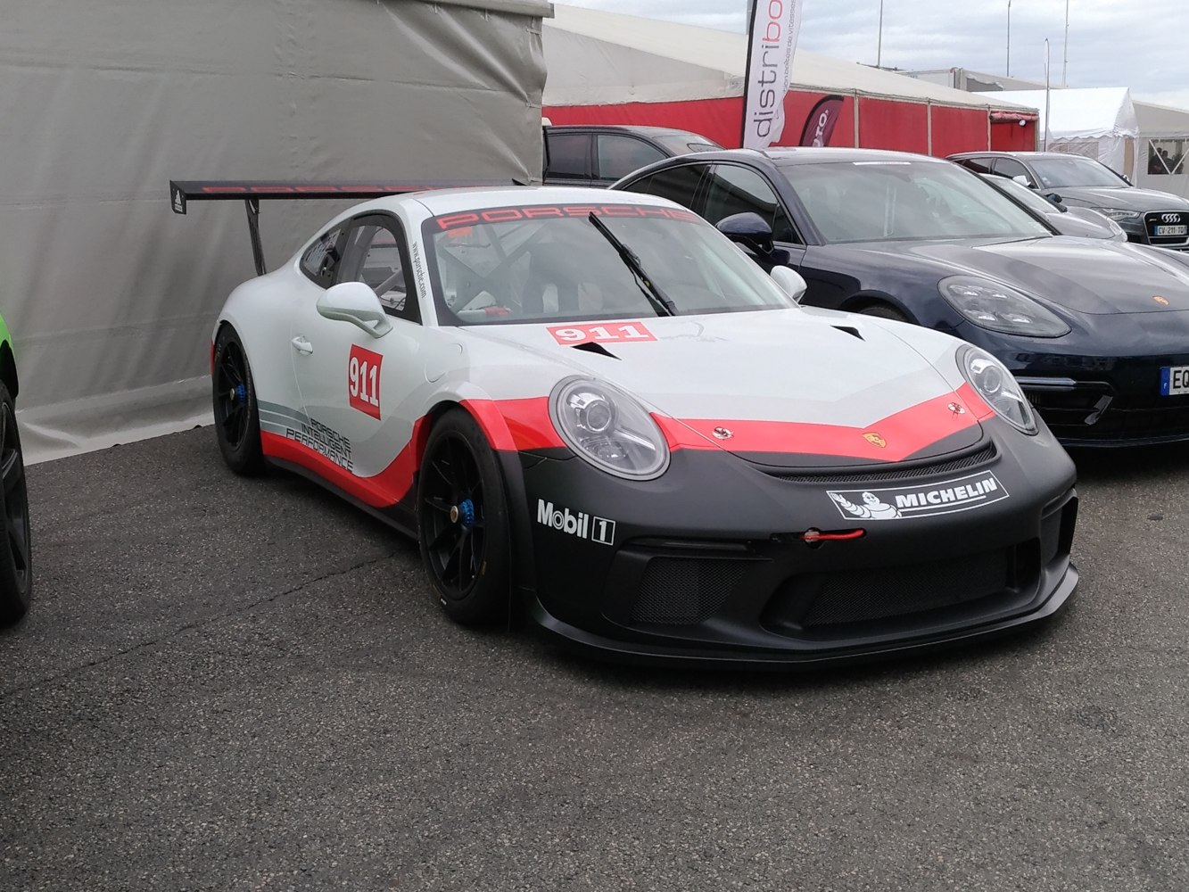 Race car with aerodynamic front, racing decals, and large rear wing