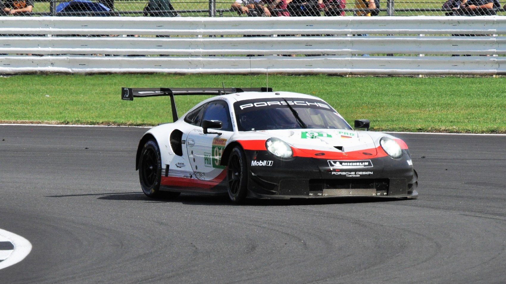 High-performance racing car with aerodynamics and rear wing on track