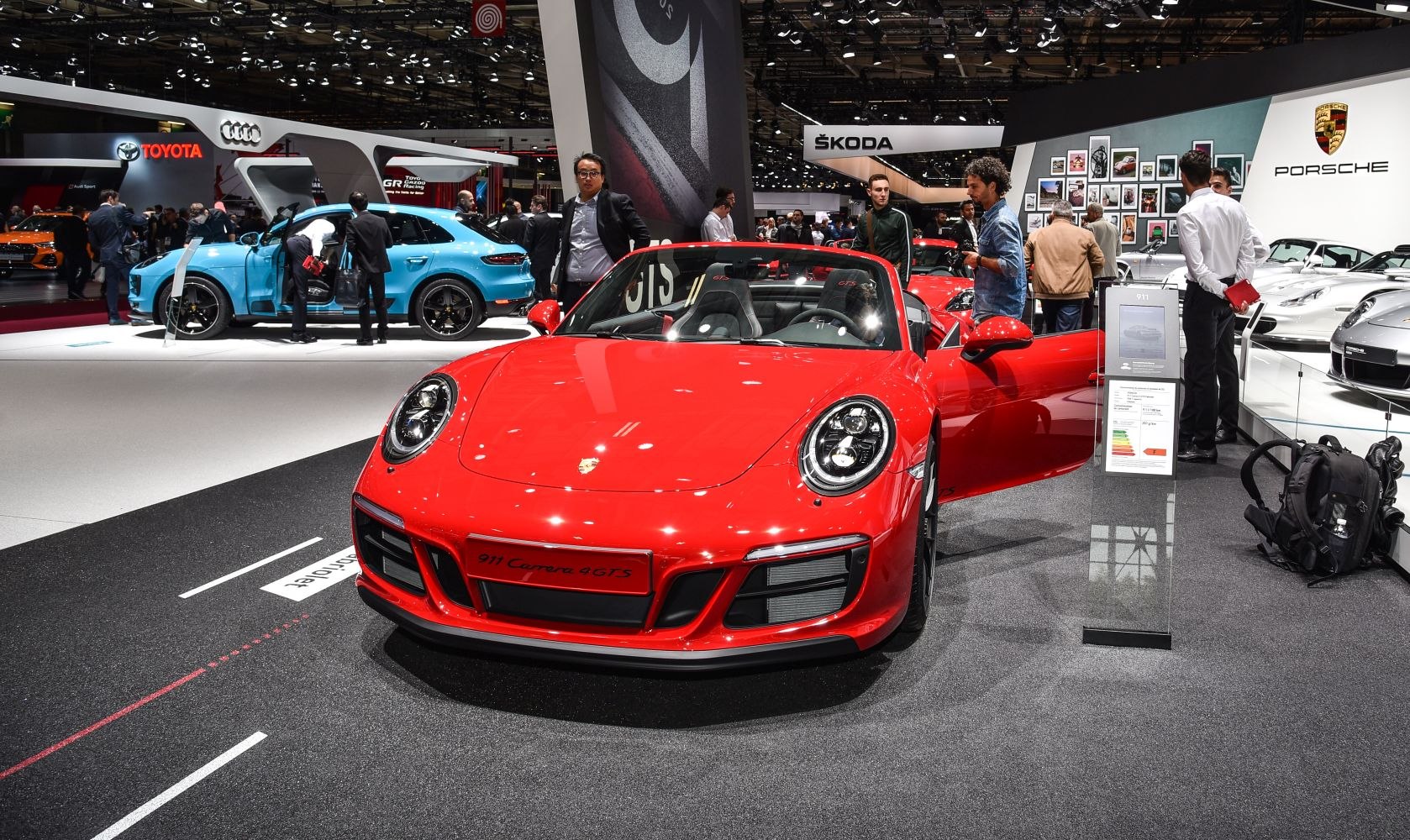 Red convertible sports car front view with open door at auto show