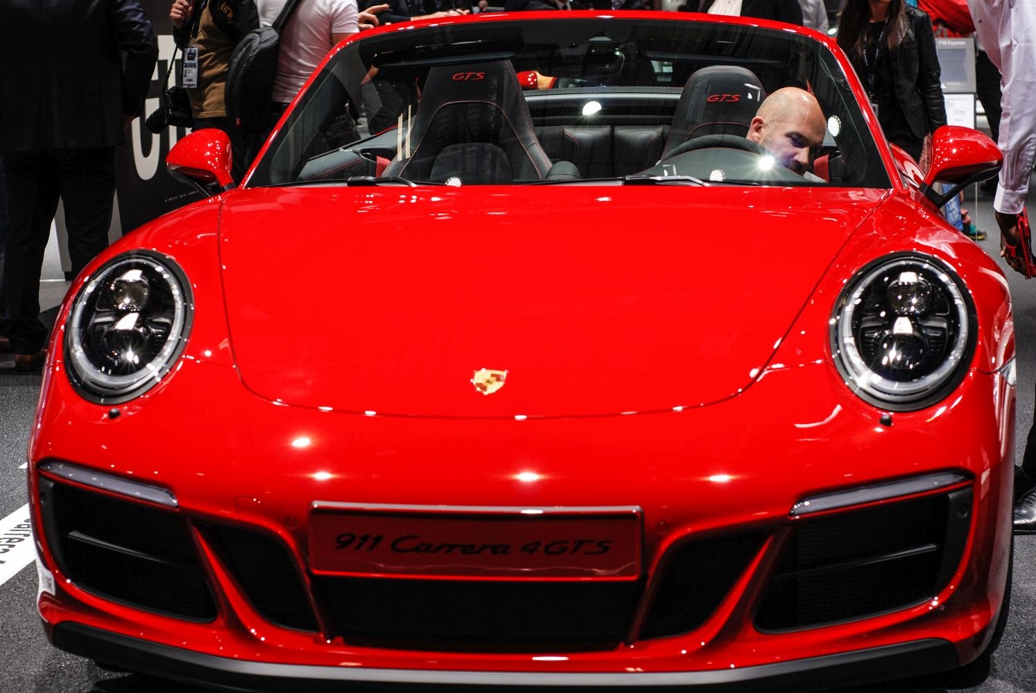 Close-up of front fascia with round LED headlights and convertible interior