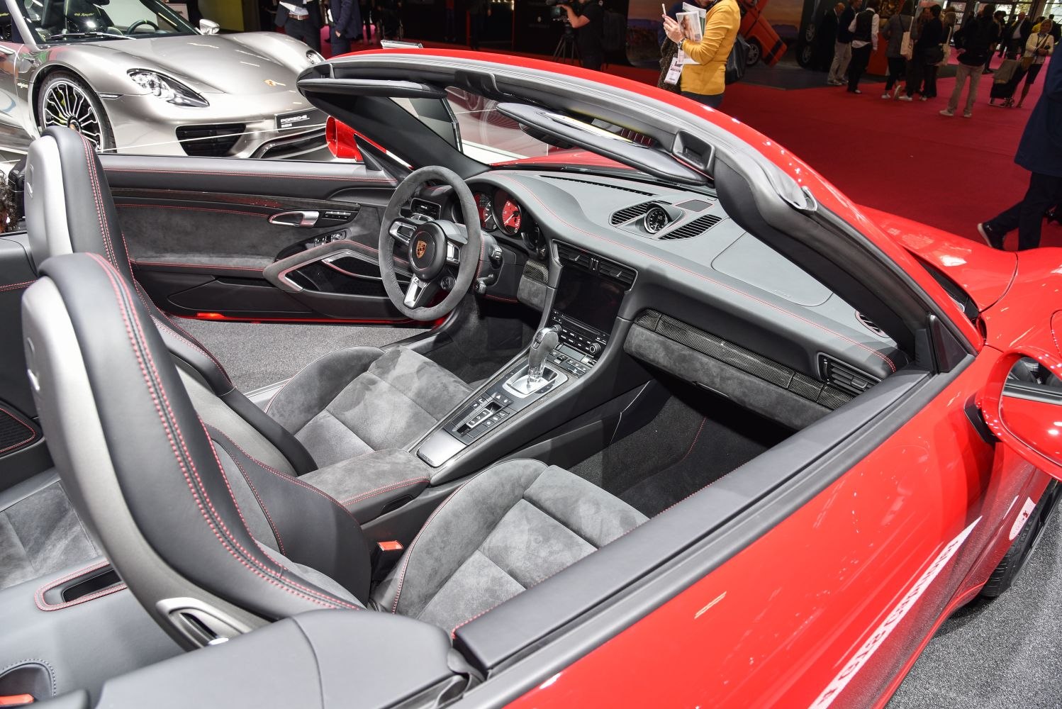 Convertible sports car interior with Alcantara seats and sleek dashboard.
