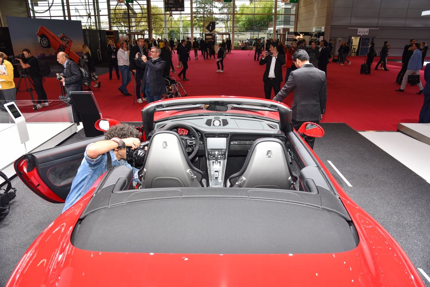 Convertible sports car interior and rear with open roof at auto show
