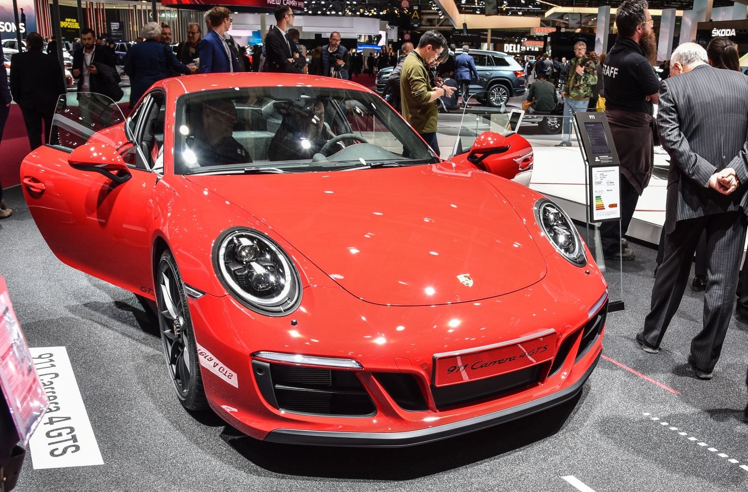 Red Porsche sports coupe front with open doors