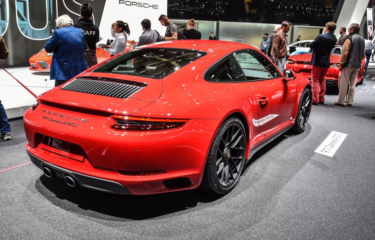 Red sports coupe rear view with dual exhaust and sleek taillights