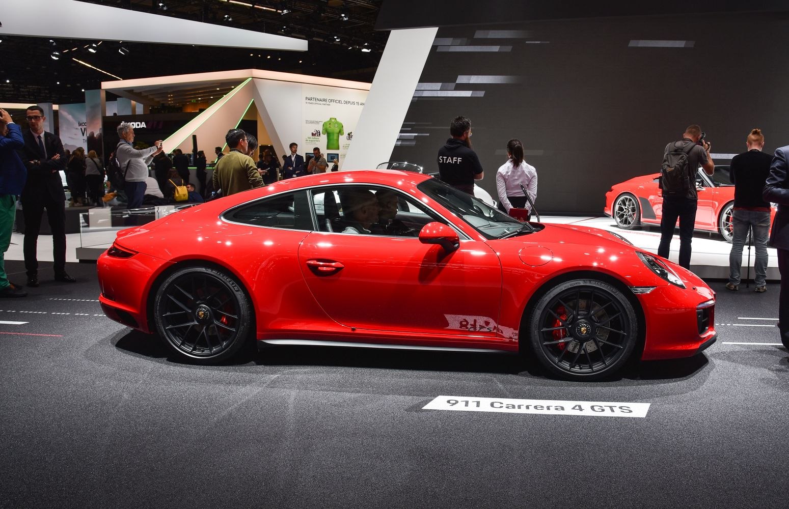 Red sports coupe with black multi-spoke alloy wheels and aerodynamic shape.