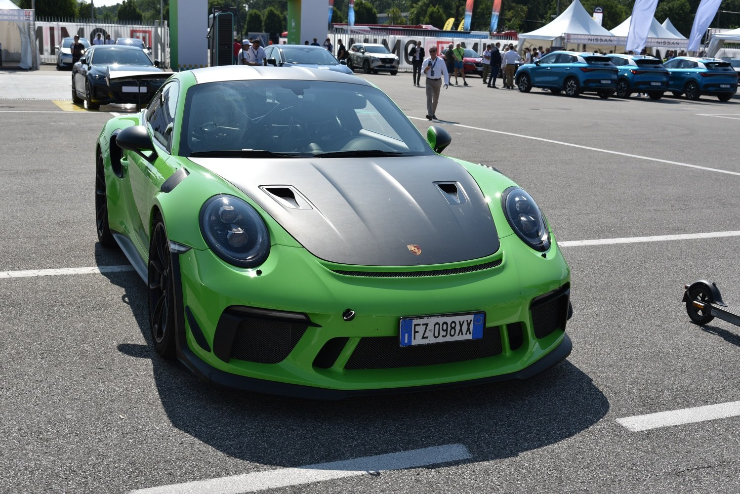 Front view of green coupe with carbon fiber hood and aerodynamic design