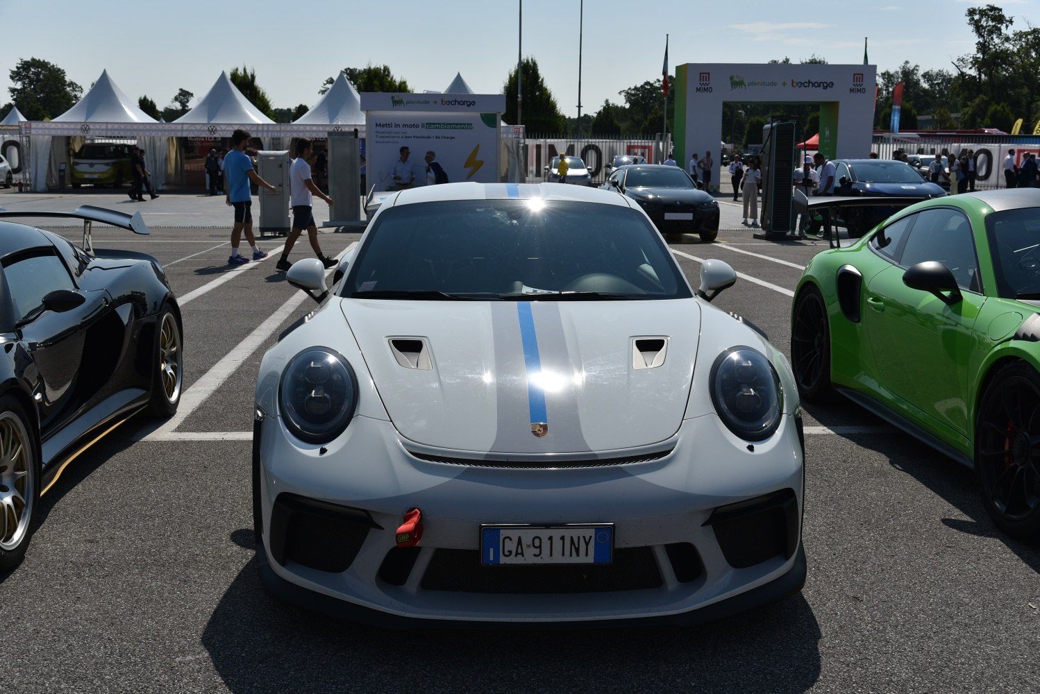Front view of sports car with blue racing stripe and hood vents