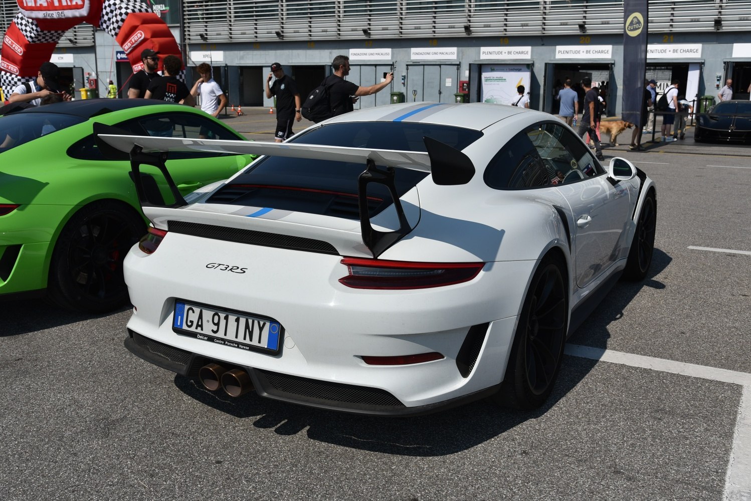 Large rear wing and dual center exhausts on a sleek sports car rear