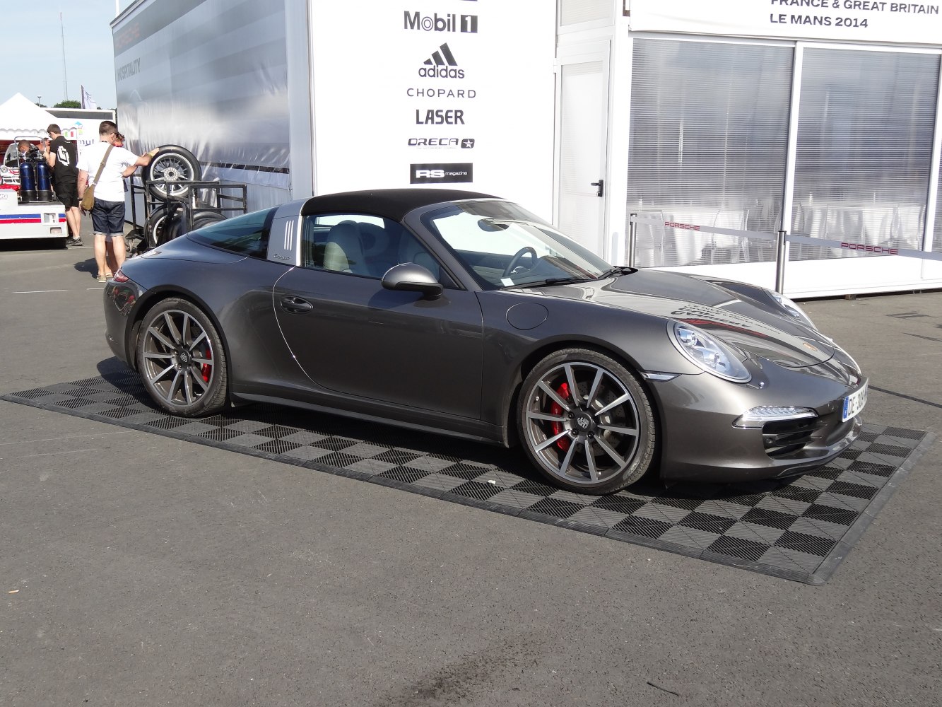 Side profile of a Porsche 911 Targa with black removable roof and sporty alloy wheels.