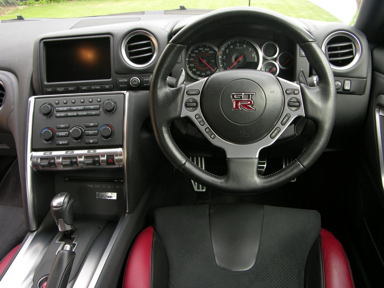 Steering wheel with GT-R emblem and dashboard control panel