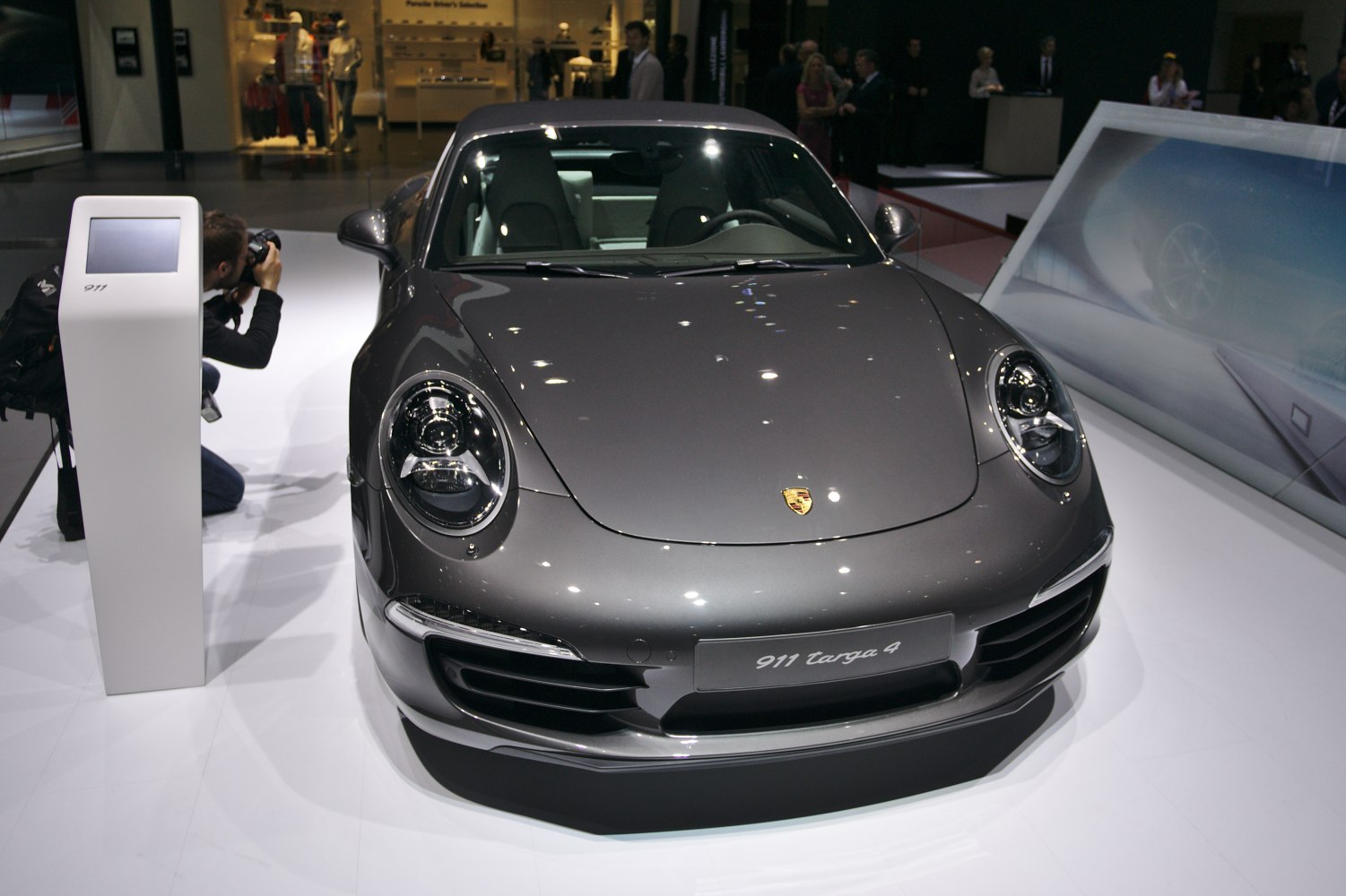 Front close-up of a sports car with round headlights and smooth hood