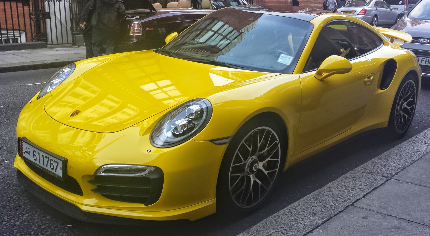 Yellow sports coupe front side view, aerodynamic body, alloy wheels
