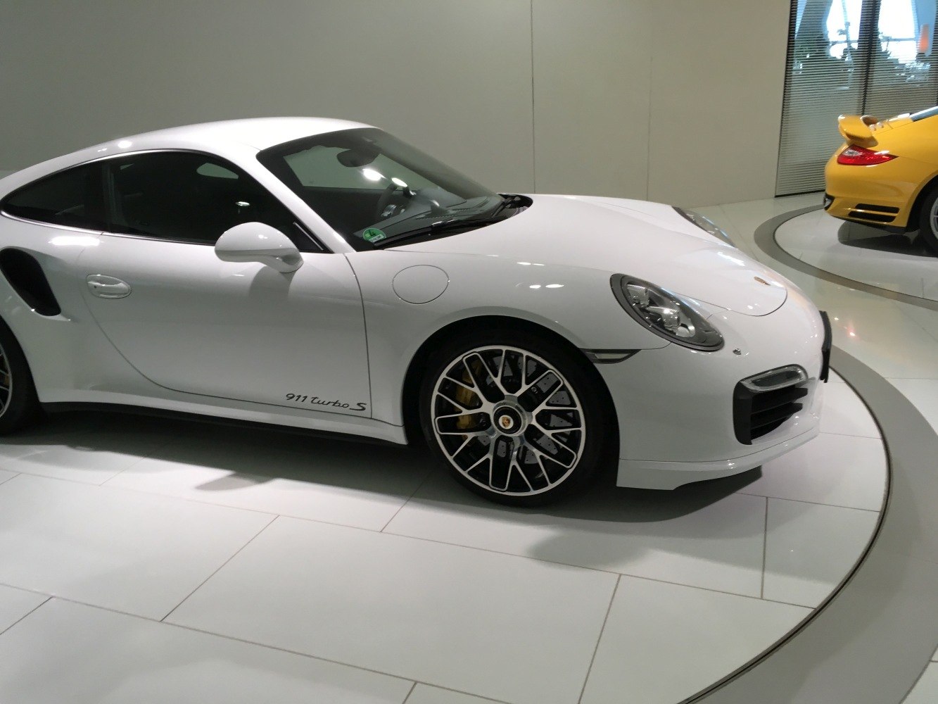 Side profile with aerodynamic curves and unique black-and-silver alloy wheels