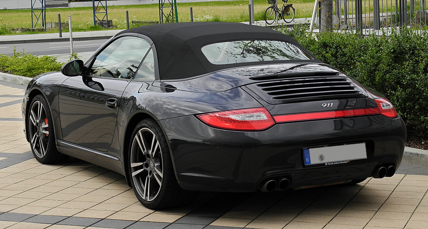 Rear view of a convertible with soft top and distinctive rear lights