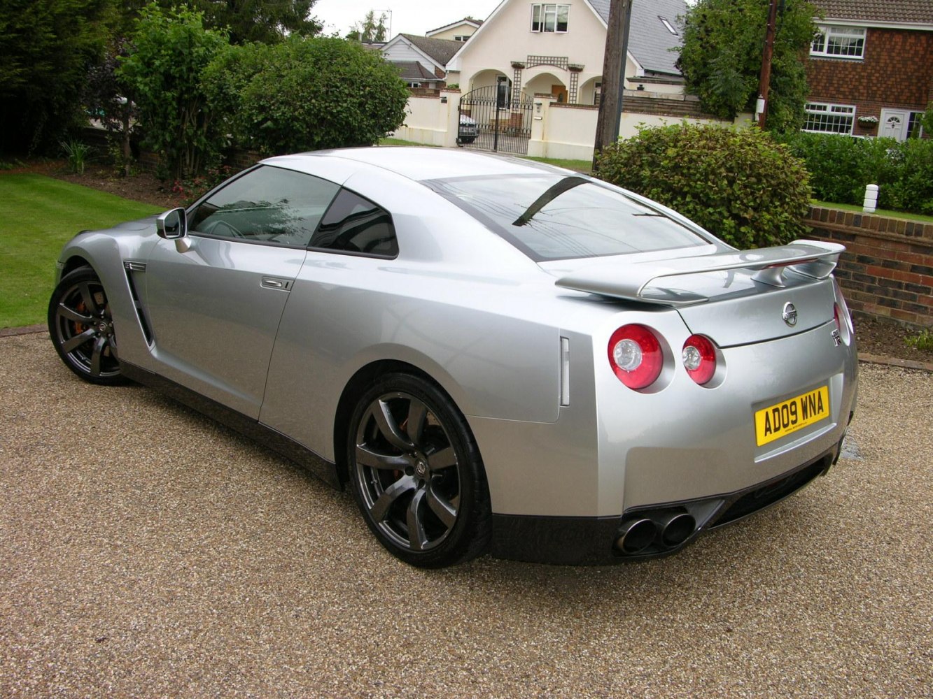 Rear angled view with spoiler and quad exhaust