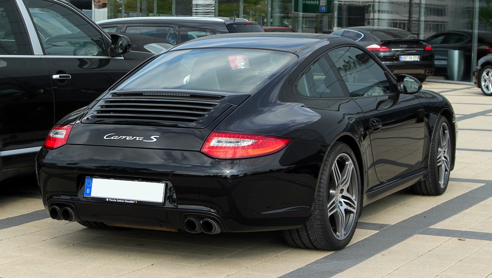 Rear view of sports coupe with distinctive taillights and quad exhaust