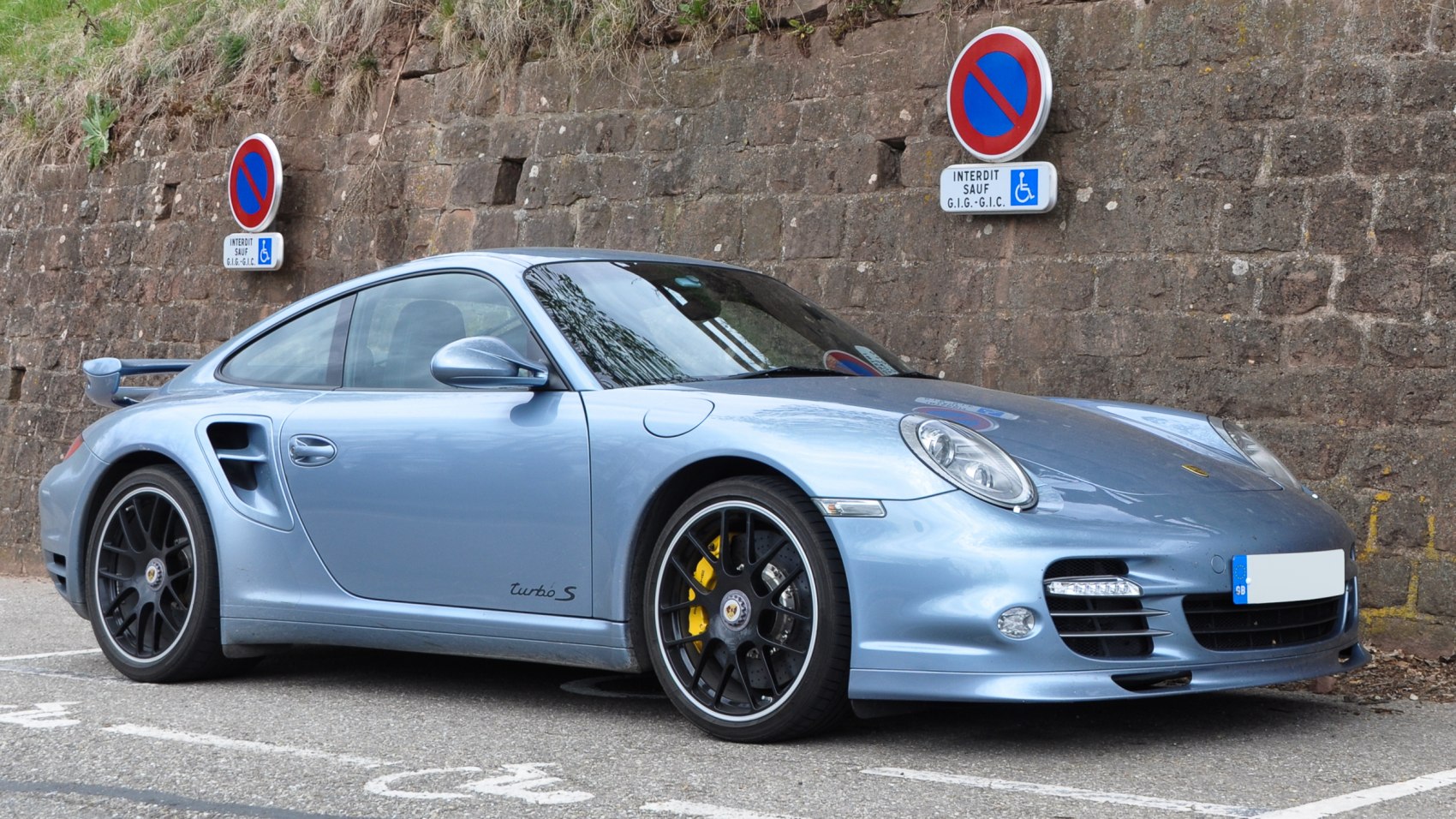 Rear wing spoiler and black sport wheels with yellow brake calipers