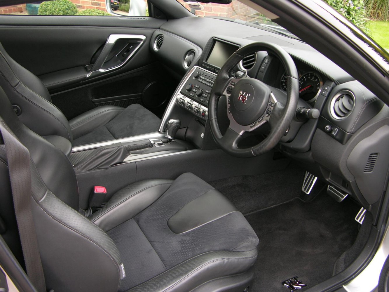 Dashboard, steering wheel, and sport seats of a car interior