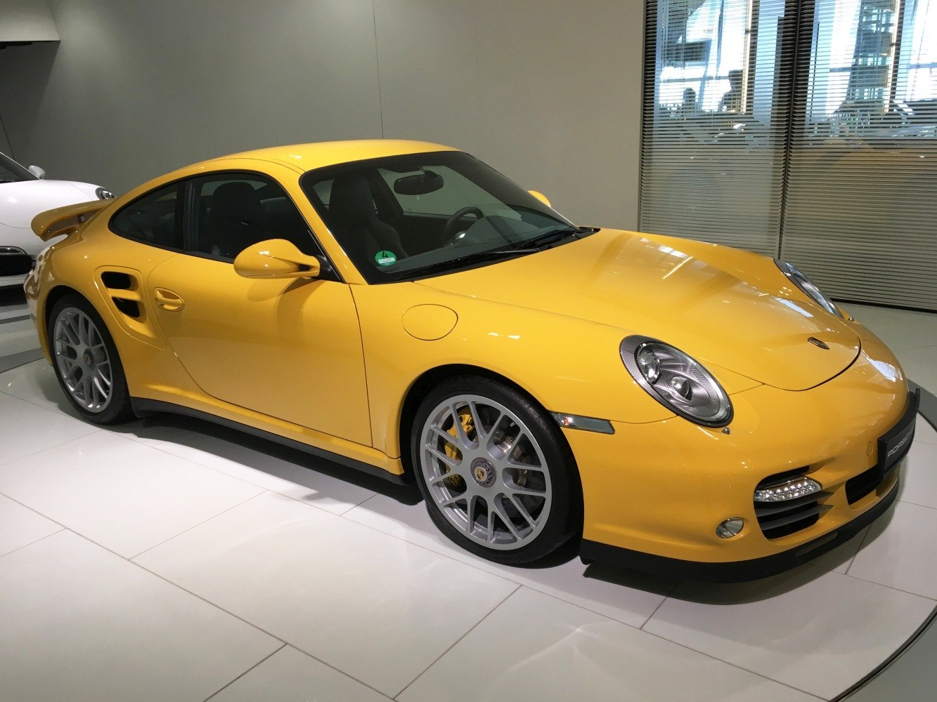 Yellow sports coupe with distinct headlights and aerodynamic body