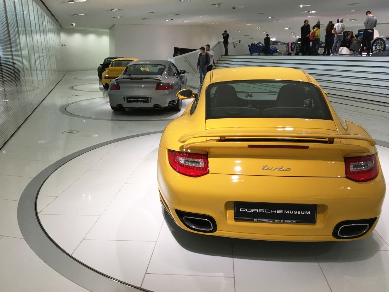 Rear view of multiple Porsche 911 (997 facelift) Turbo cars in a museum setting