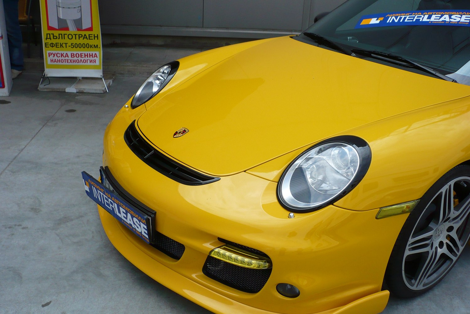 Close-up of Porsche 911 997 facelift headlights, hood, and front grill