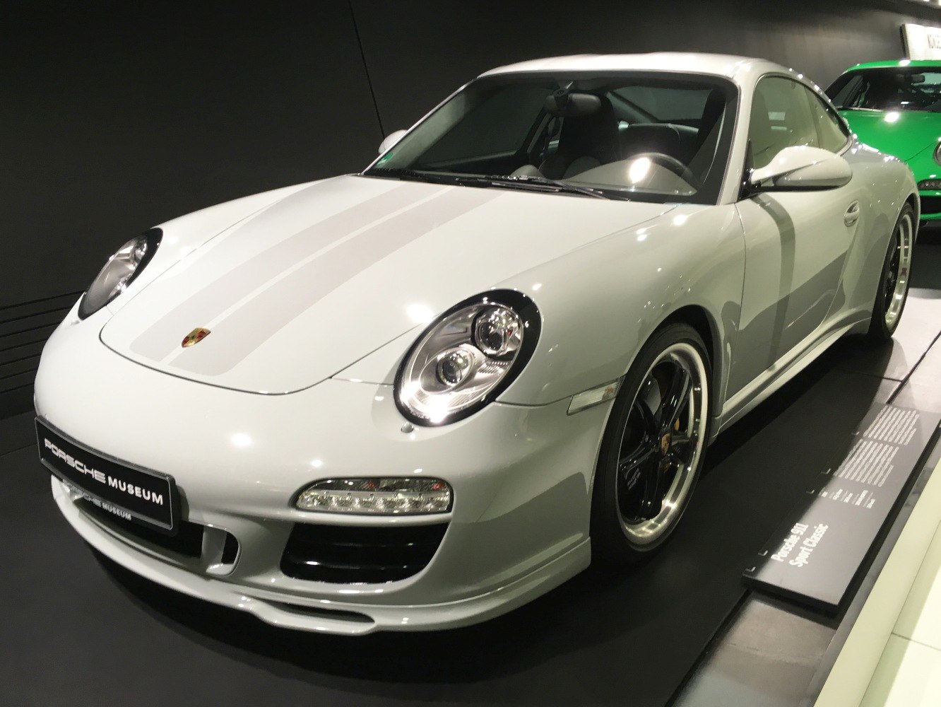 Front side view showing round headlights and sporty alloy wheels