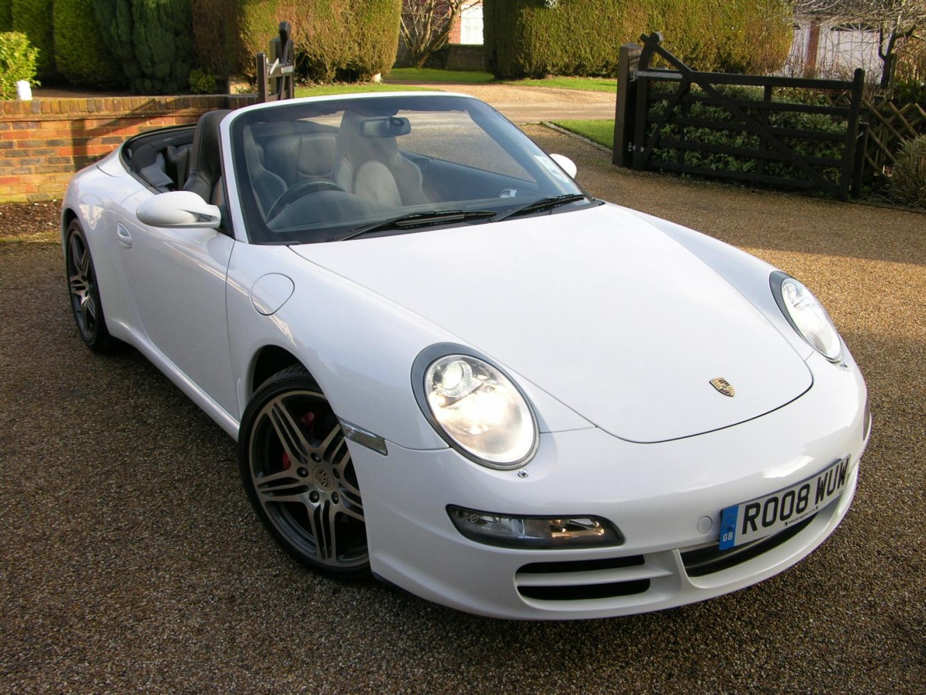 Convertible front view with headlights on and alloy wheels