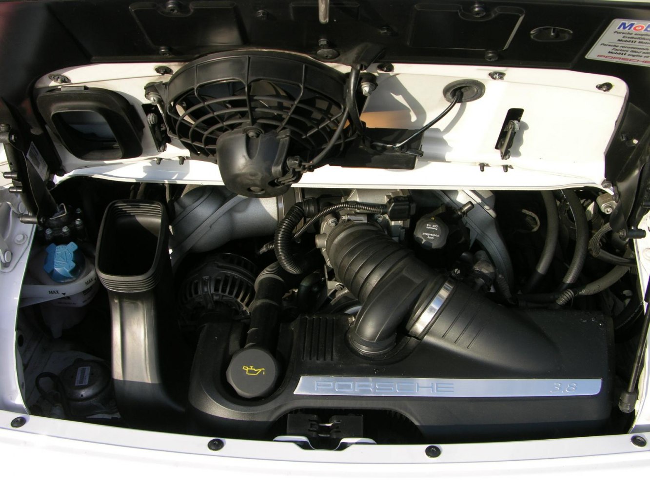 Engine bay with 3.8 labeled intake and cooling fan