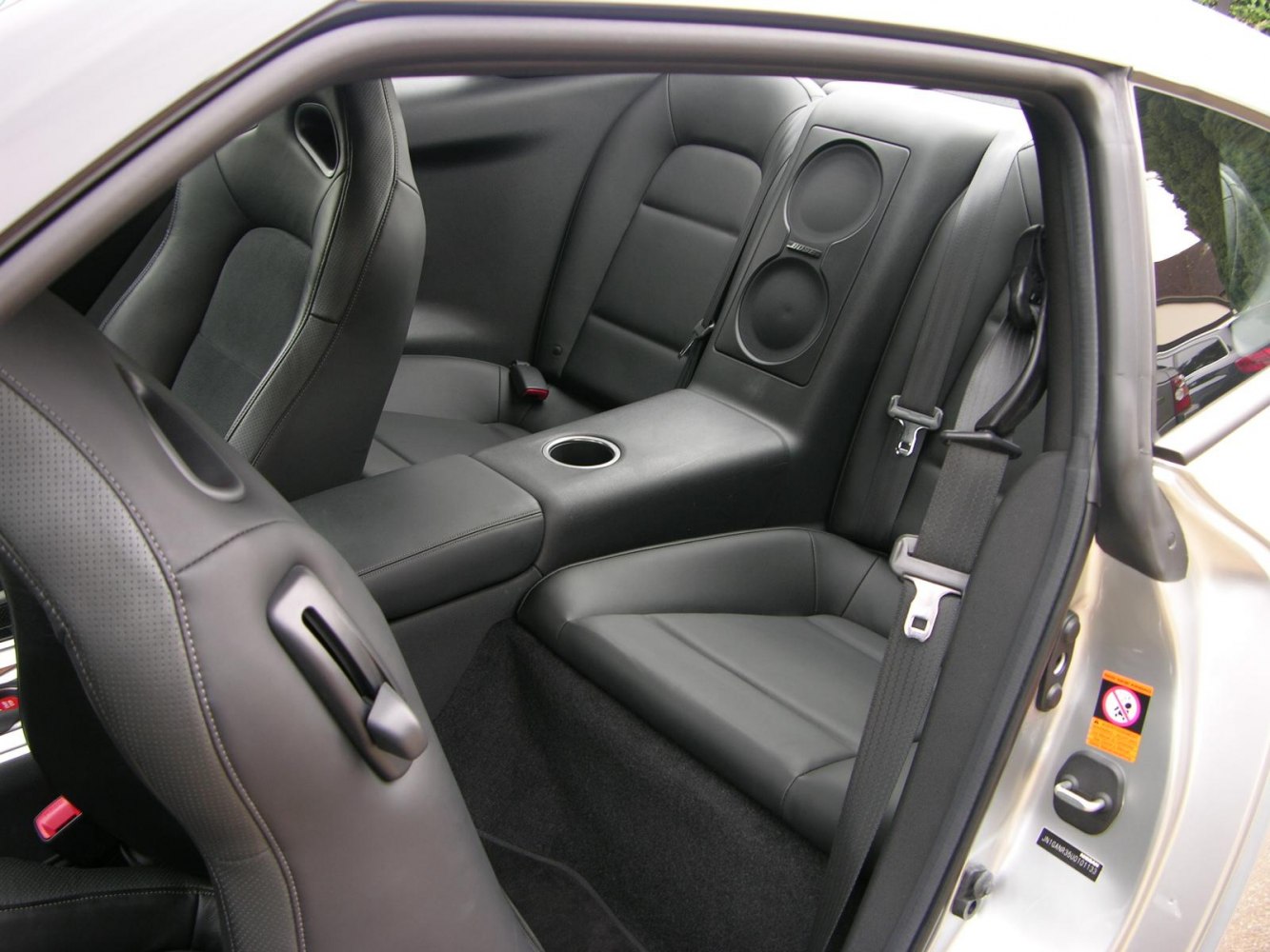 Rear black leather seats with center console and integrated Bose speakers